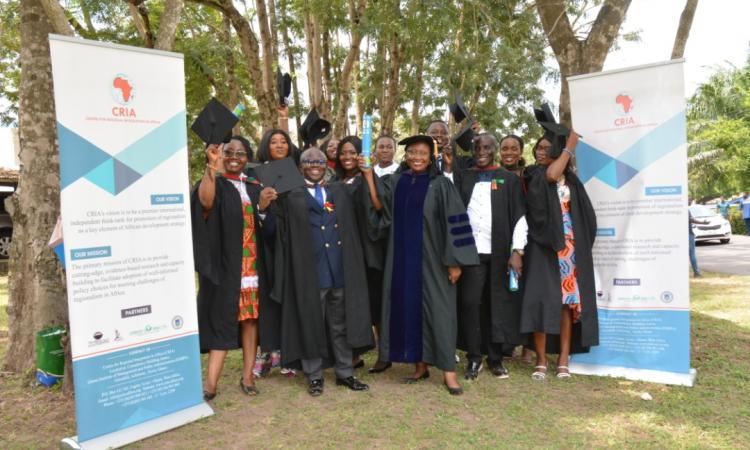 graduants holding hats high